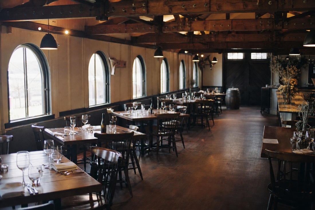 Cozy restaurant dining room set inside a converted railway building with exposed timber beams
