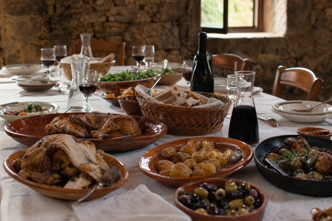 Traditional Portuguese lunch spread with regional dishes and wine on a quinta dining table