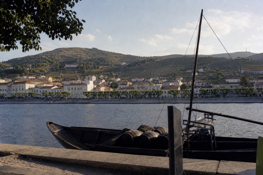 Peso da Régua riverfront town spread along the Douro with vineyard hills behind